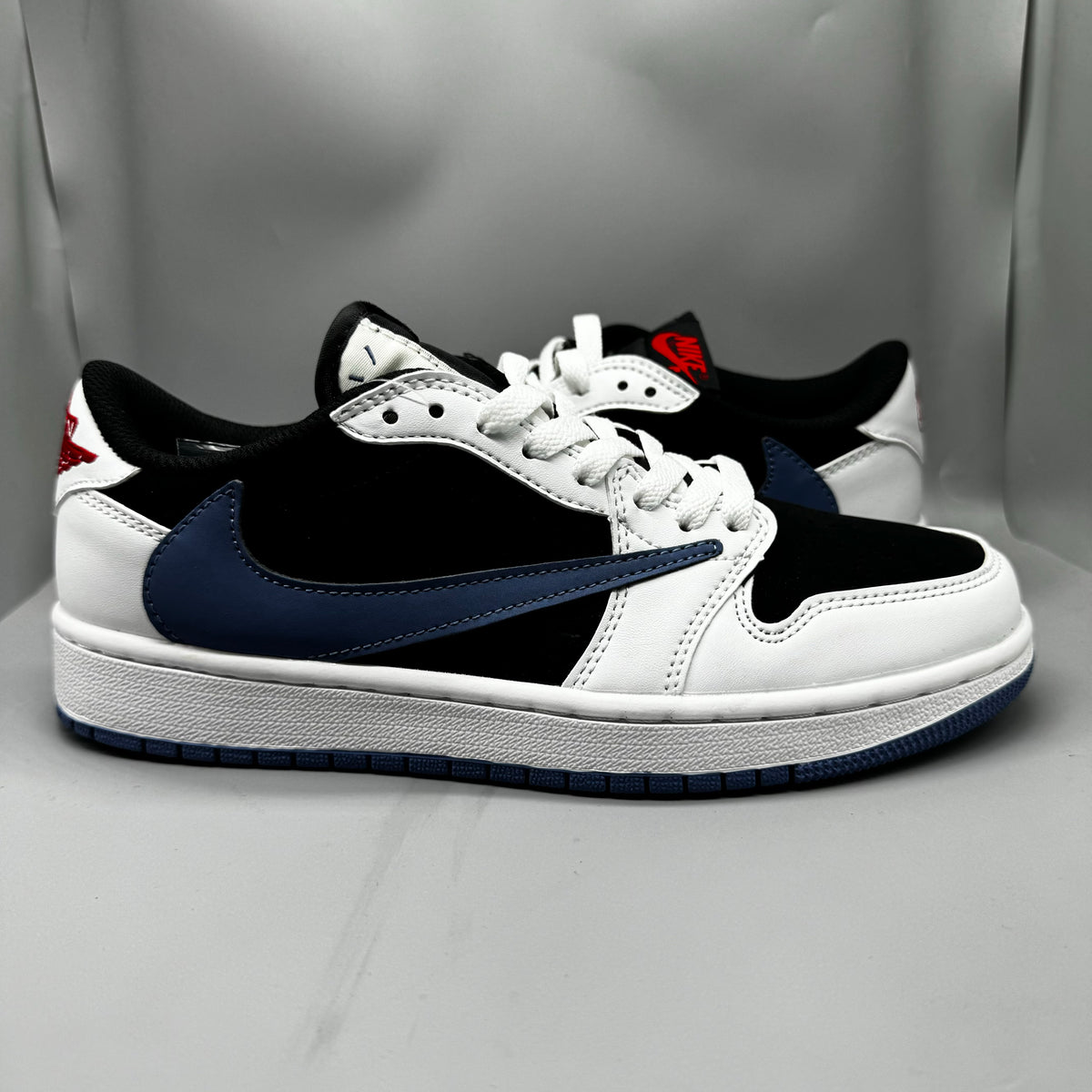 Air Jordan 1 Low White & Black Blue Reverse Swoosh Sneakers