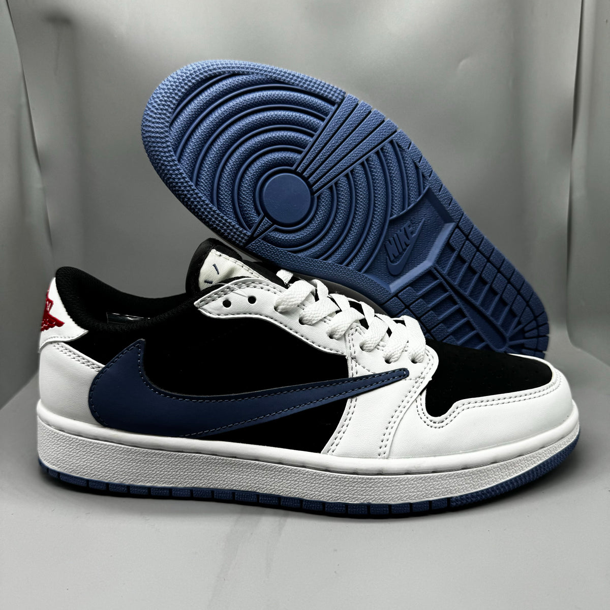 Air Jordan 1 Low White & Black Blue Reverse Swoosh Sneakers